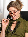 Mature office girl Delilah gets down and dirty on her desk in here