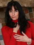 Long haired brunette MILF Scarlett D shows off her mature body